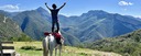 A rider standing on the back of his trail horse looking at the panorama mountain view